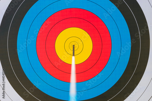 Archery target with arrow in bull's eye photo