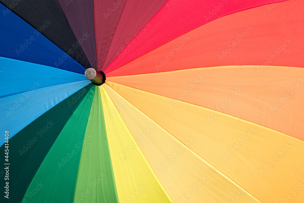 Close-up of a rainbow colored umbrella, LGBTQ lesbian gay pride background with copy space Close-up of a rainbow colored umbrella, LGBTQ lesbian gay pride background with copy space