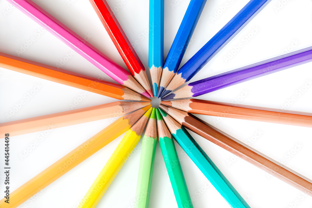 Colorful rainbow colored pencils in circle on white background
