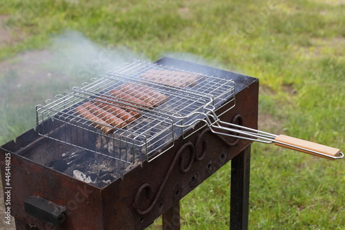 Tasty sausages on the grill is fried on the bbq with smoke, Cooking outdoors