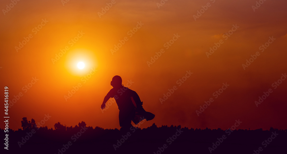 running superhero silhouette moving forward with determination running and exercise concept of a boy who is a superhero