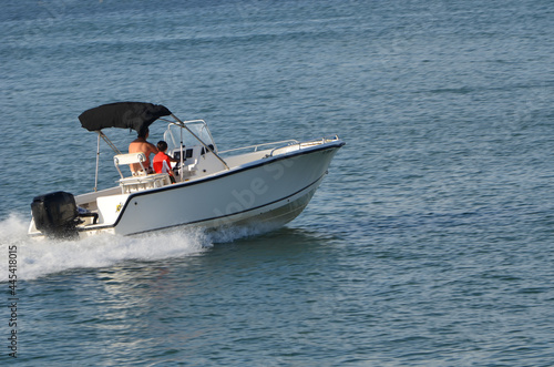 Motor boat powered by one outboard engine speeding on the Florida Intra-Coastal Waterway.