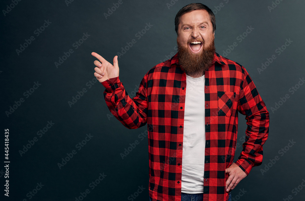 Carefree good-looking outgoing guy pointing left and smiling. Handsome bearded man promote healthcare product or recommend store, found good place celebrate holidays, made choice Carefree good-looking outgoing guy pointing left and smiling. Handsome bearded man promote healthcare product or recommend store, found good place celebrate holidays, made choice