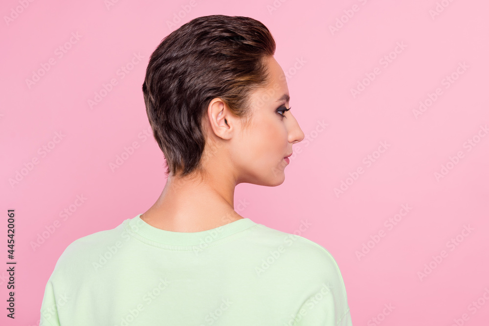 Back rear view photo of young attractive girl look empty space hairdo isolated over pink color background Back rear view photo of young attractive girl look empty space hairdo isolated over pink color background