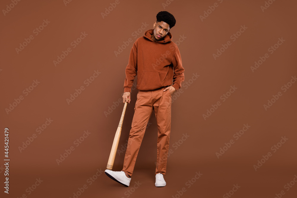 Full body photo of anger short hairdo young guy hold bit dress sportswear trousers sneakers isolated on brown background Full body photo of anger short hairdo young guy hold bit dress sportswear trousers sneakers isolated on brown background