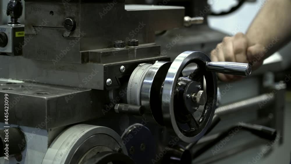 Close-up of a worker's hand moves a part of the machine to the camera. Close-up of a worker's hand moves a part of the machine to the camera.