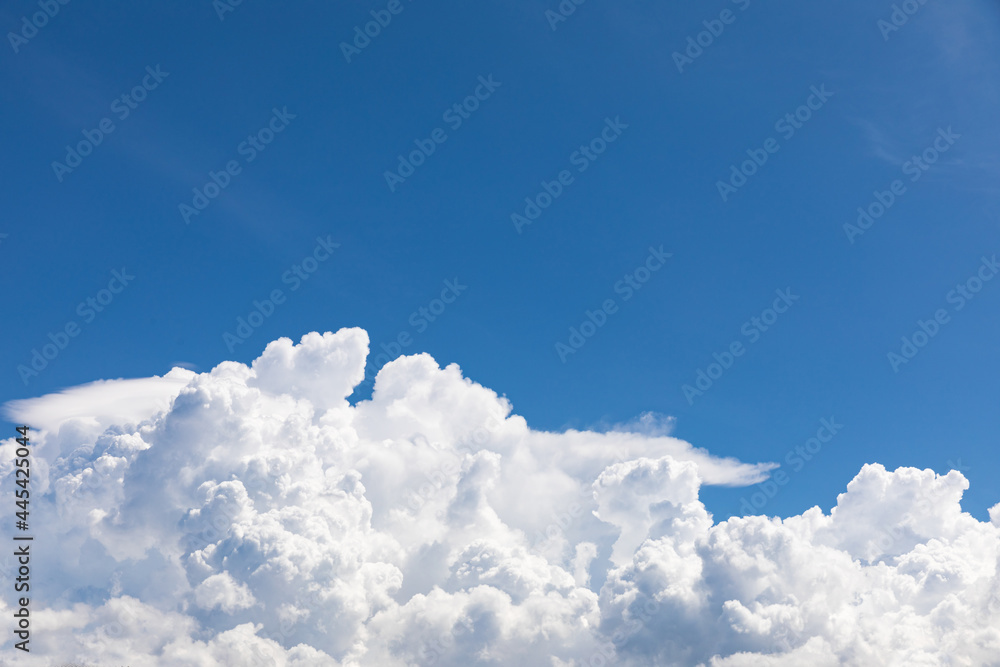 Cumulonimbus, puffy white clouds in the blue sky Cumulonimbus, puffy white clouds in the blue sky