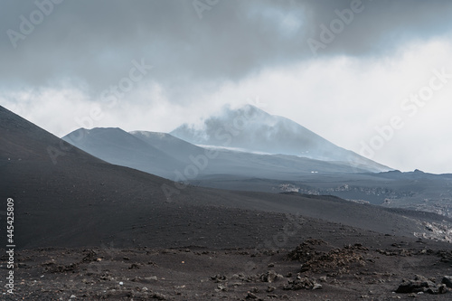 Crater of Etna,Sicily,Italy.Adventure outdoor activity.Excursion on summit of volcano.Parco dell'Etna,protected nature area.Travel freedom background.Hiking people on summer vacation.Active volcano