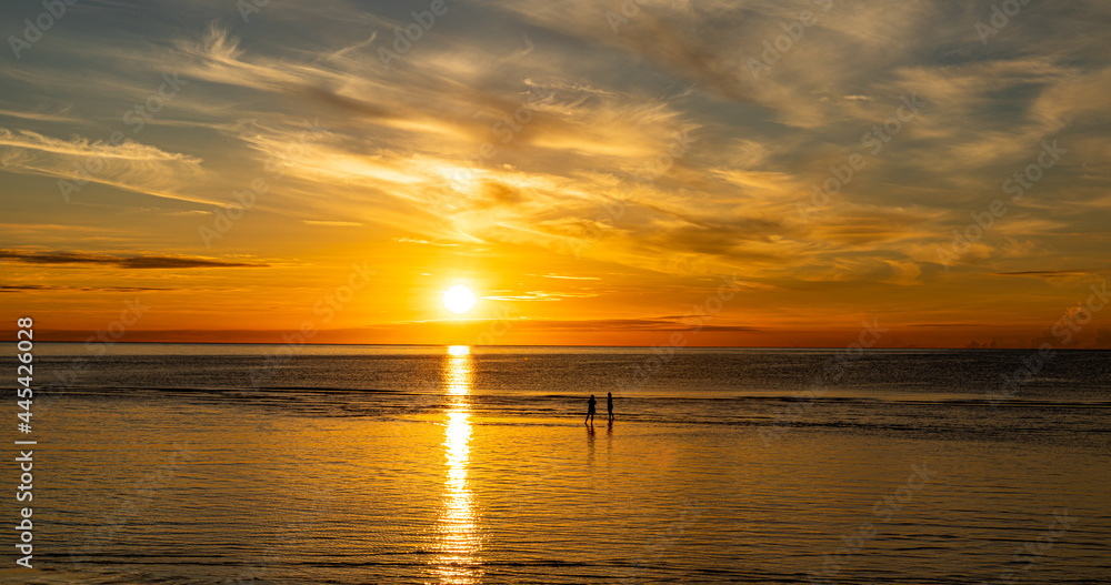 Silhouette, Tourists stand to take pictures on the beach of Hua Hin morning sunrise