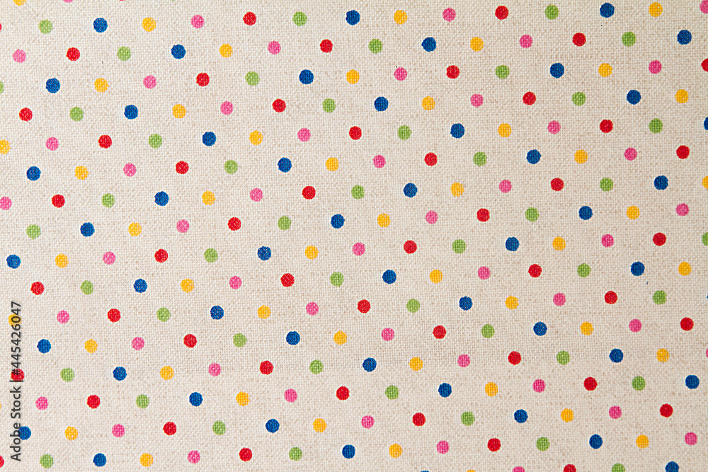 White fabric with multicolored small polka dots.Fabric background and texture for design White fabric with multicolored small polka dots.Fabric background and texture for design