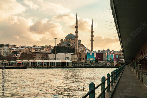 Turkey, Istanbul, Golden Horn canal at dusk with Yeni Cami mosque in background photo