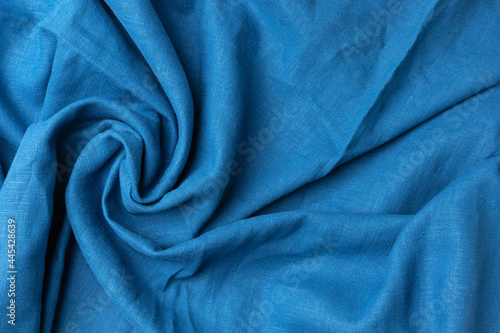 Abstract blue fabric luxurious softness smooth for design backdrop. Cotton textile is wave beautifully for wallpaper. Design textured, abstract, background.