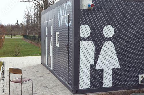 Modern gray toilet depicting figures of a man and a woman in the park.