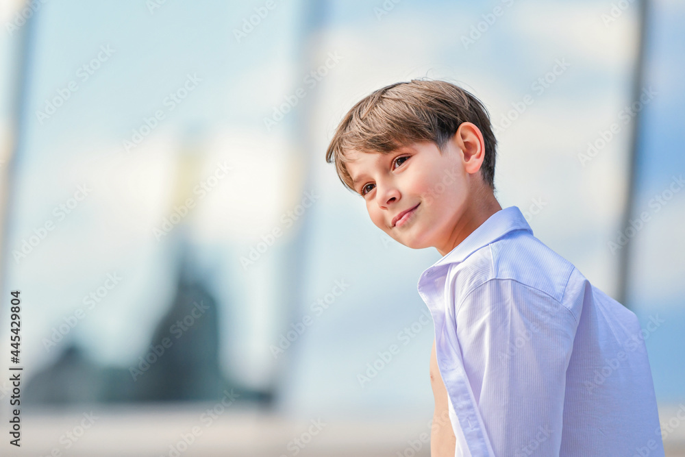 Portrait of a happy boy in an unbuttoned shirt on summer sky background Portrait of a happy boy in an unbuttoned shirt on summer sky background