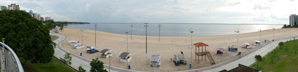 Panorama view of Ponta Negra beach in Manaus Amazon Brazil, in the afternoon with light cloudy weather, empty beach because of Corona Logdown