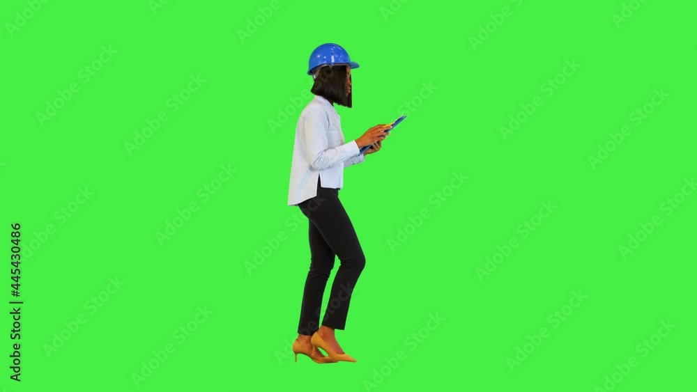 Confident professional construction inspector woman walk, check building development and make notes on a Green Screen, Chroma Key. Confident professional construction inspector woman walk, check building development and make notes on a Green Screen, Chroma Key.