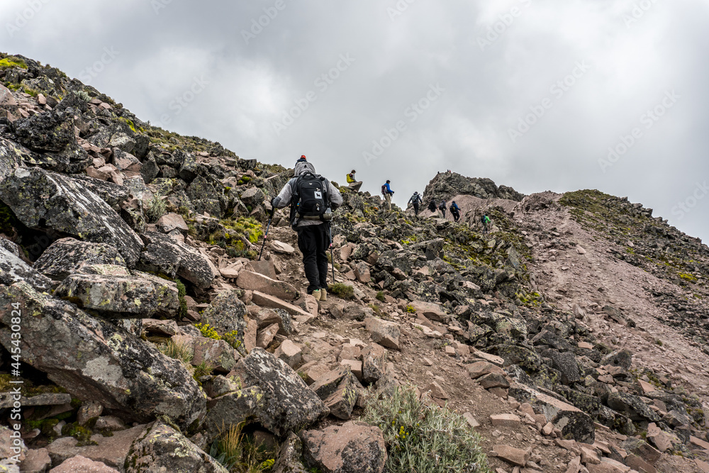 A group of mountaineers climbs to the top of a mountain