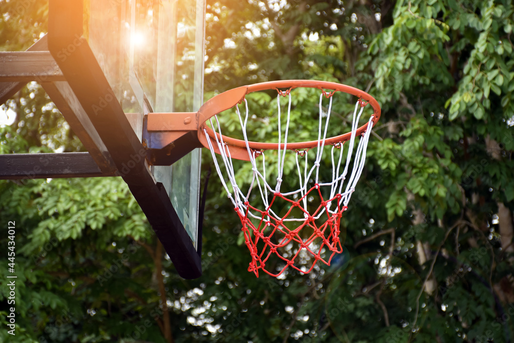 Basketball hoop on outdoor shooting target, blurred and sunlight edited background. Soft and selective focus on basketball hoop.