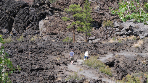 tourists hike into lava flow