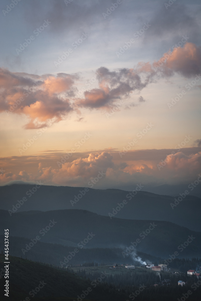 sunset in the mountains with distant mountains silhouettes