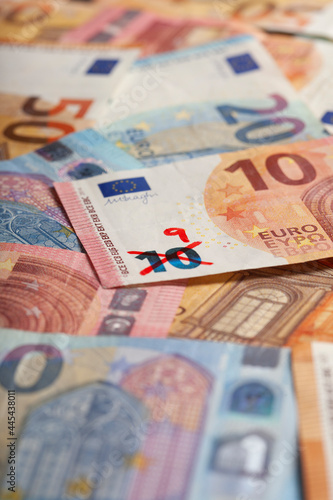 Ten euro banknote with number 9 written on it symbolizing devaluation of currency photo