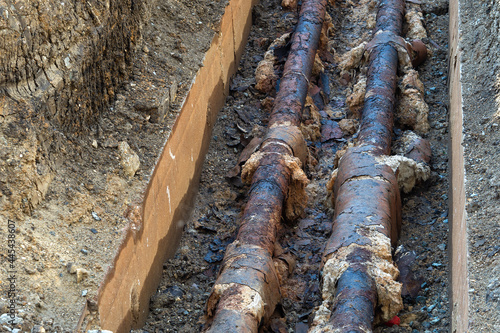 Old rusty sewer pipes in a trench. Repair of old pipes. Old pipes were excavated for repair.