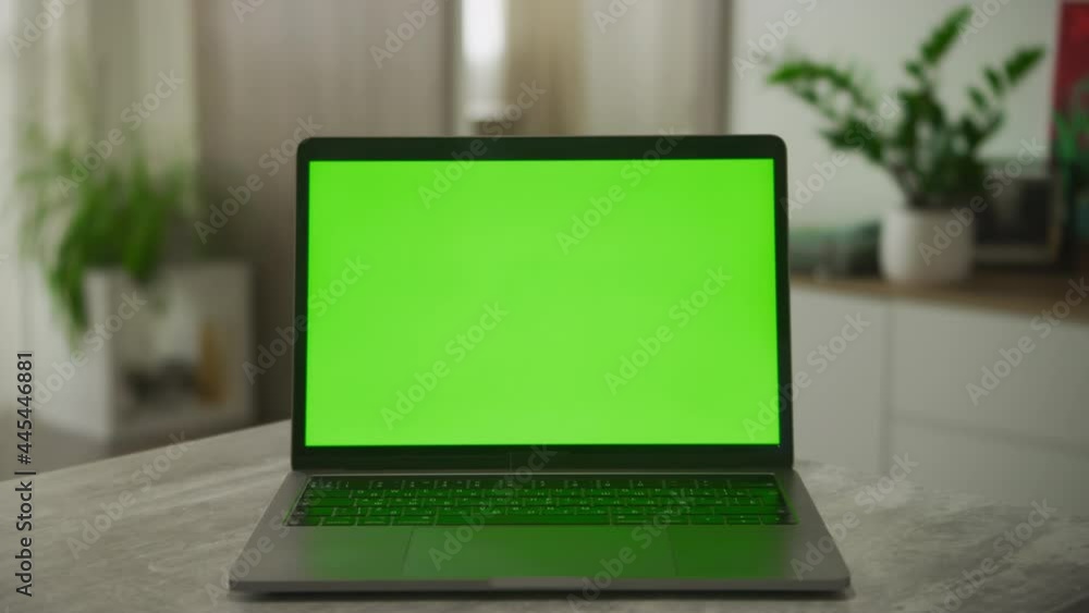 Static video of an open laptop computer with a green screen chromakey on it Static video of an open laptop computer with a green screen chromakey on it
