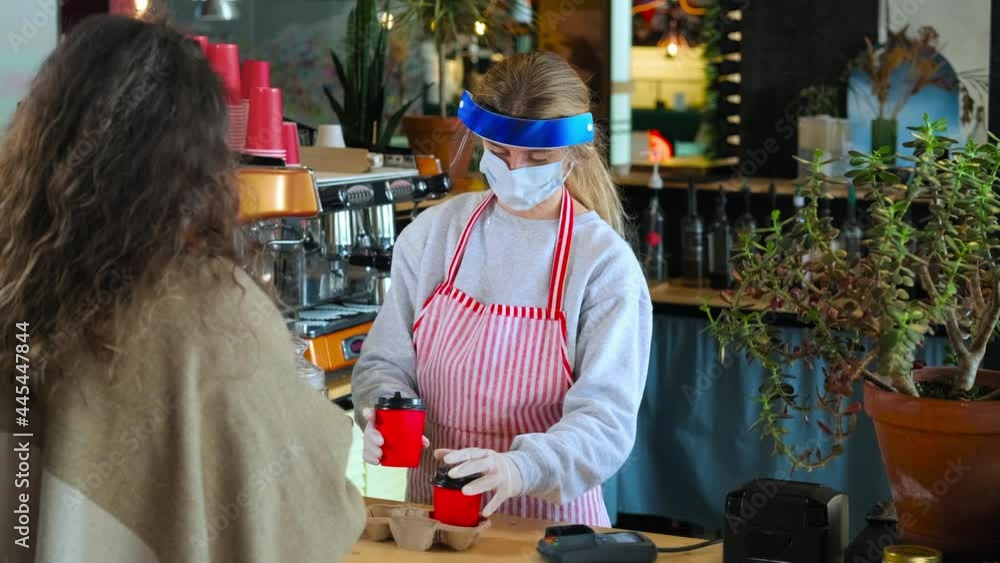 service in coffee shop during pandemic of coronavirus, protective equipment on client and staff service in coffee shop during pandemic of coronavirus, protective equipment on client and staff