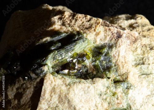 Blotting of green actinolite mineral crystals in rock from Ural, Russia. For geology websites, stone collection catalog, Natural Science museum wall chart. photo