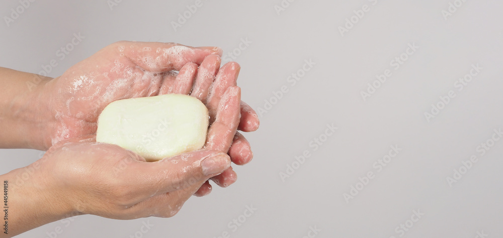 Fototapeta premium Hands washing gesture with bar soap and bubble on white background.