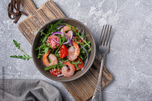 Healthy salad with fresh arugula  cherry tomatoes  tasty shrimps and onion