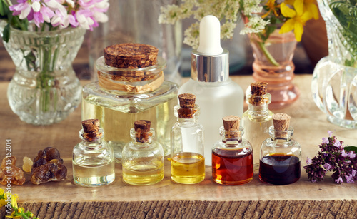 Fototapeta Naklejka Na Ścianę i Meble -  Selection of essential oil bottles with frankincense, oregano and other herbs