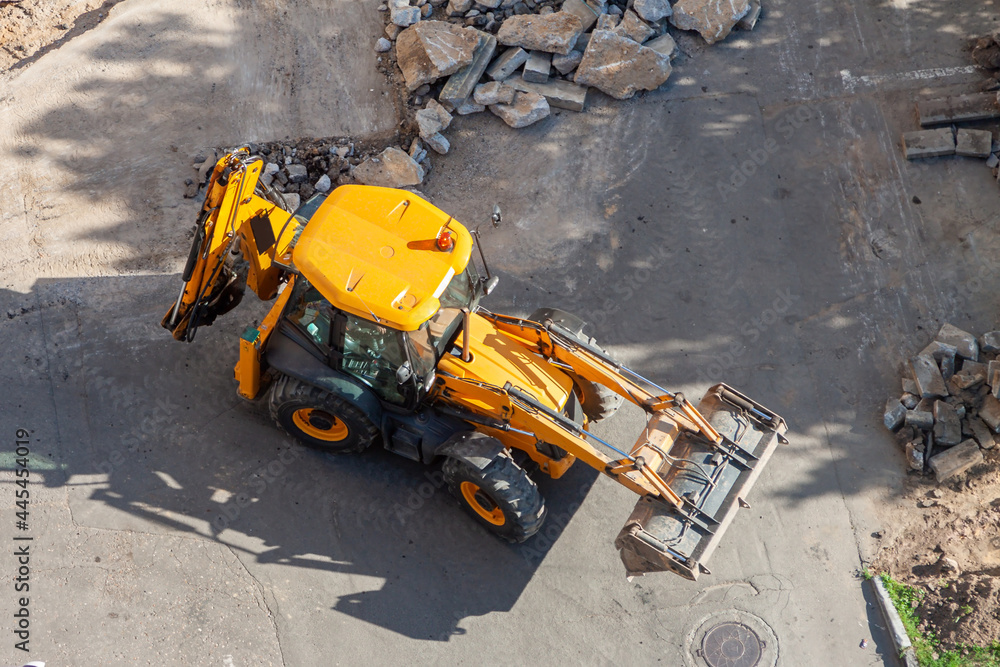 Aerial view yellow wheel loader excavator construction site with rubble road Aerial view yellow wheel loader excavator construction site with rubble road