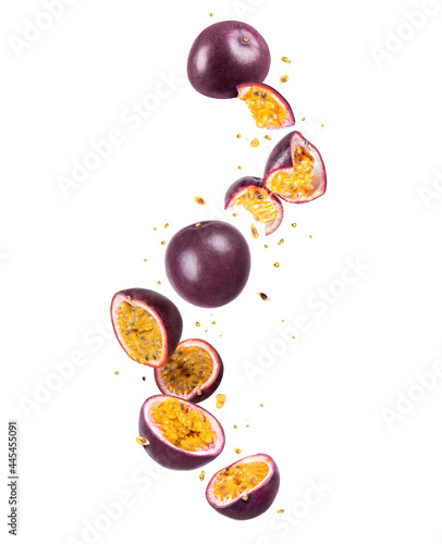Whole and sliced fresh passion fruit (passiflora) in the air on a white background photo