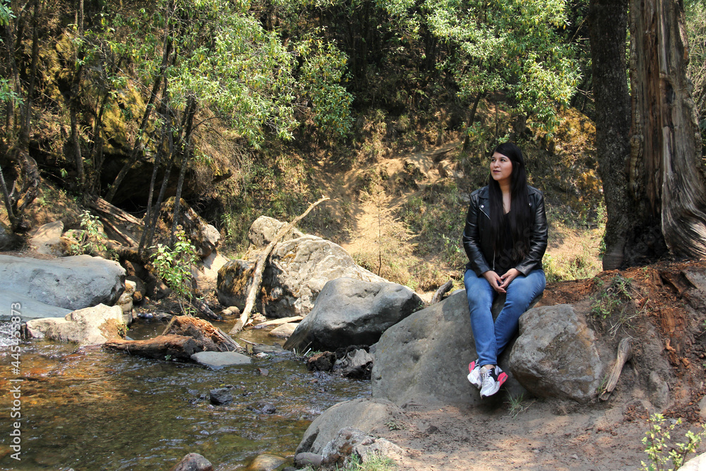 Woman alone in the middle of the forest exploring and meditating among rivers and waterfalls
Woman alone in the middle of the forest exploring and meditating among rivers and waterfalls