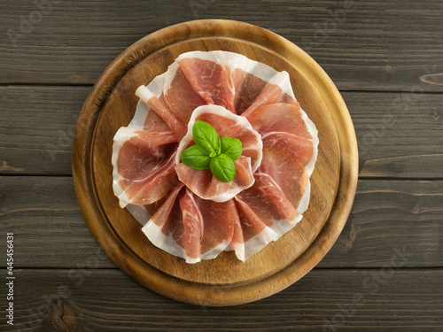 Dish with raw ham. Slices of prosciutto crudo. Platter of jamon. Italian food. Flat lay.