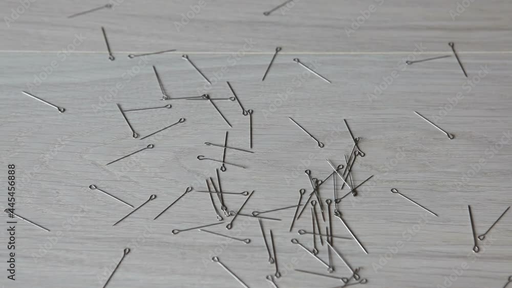 The needles are scattered on the floor. Dressmaker pins fall to the floor.
The needles are scattered on the floor. Dressmaker pins fall to the floor.