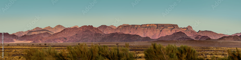 Wide panoramic view of the Naukluft mountain range at sunset. Sossusvlei dunes in Namib Naukluft national park, Namibia. Wide panoramic view of the Naukluft mountain range at sunset. Sossusvlei dunes in Namib Naukluft national park, Namibia.