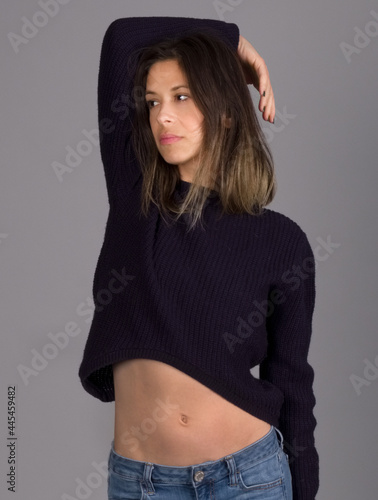 Standing Woman in Cropped Blue Sweater and Jeans photo