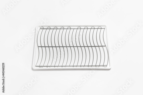 Stainless steel cutlery and dish drainer isolated on white background. High-resolution photo.