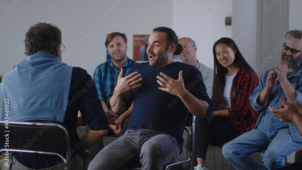 Optimistic reformed addict talking about life without alcohol during AA meeting Optimistic reformed addict talking about life without alcohol during AA meeting