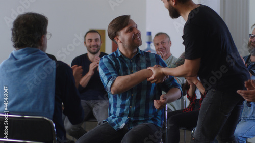 Fotografie People applauding to reformed addict during AA meeting