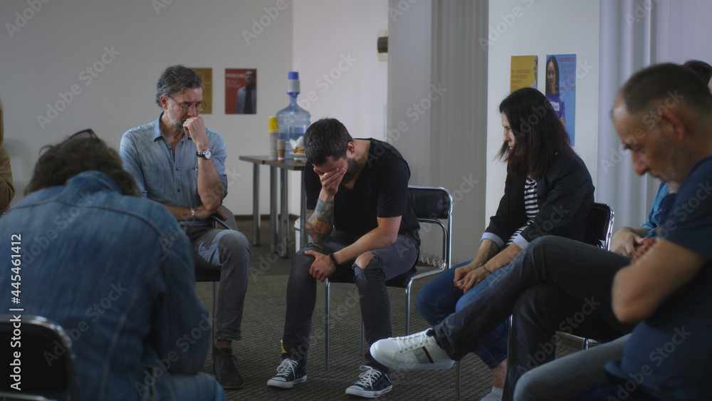 Male addict screaming in anger and crying during group meeting Male addict screaming in anger and crying during group meeting