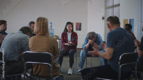 Upset man crying during group psychotherapy session photo