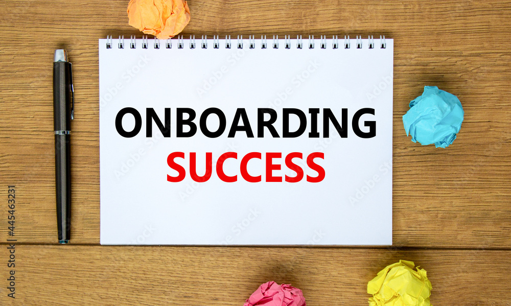 Fototapeta premium Onboarding success symbol. Words 'Onboarding success' on white note on beautiful wooden table, colored paper, black metallic pen. Business, onboarding success concept. Copy space.