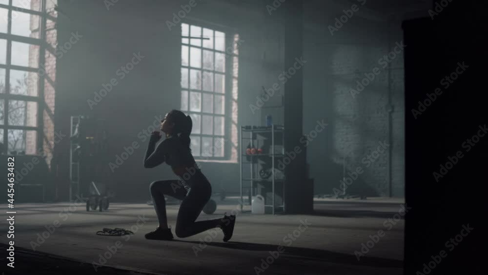 Woman doing lunge squat exercise. Bodybuilder making frontal squats with lunges Woman doing lunge squat exercise. Bodybuilder making frontal squats with lunges