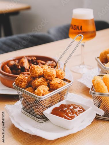 Ration of balls stuffed with cheese and chicken wings photo