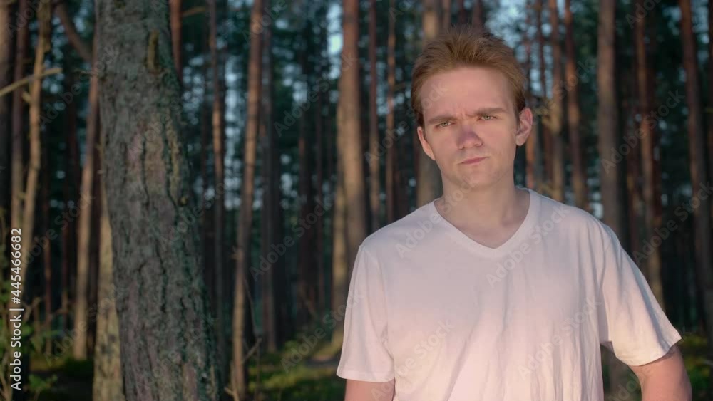 Young guy in a white t-shirt shows emotion - suspicion Young guy in a white t-shirt shows emotion - suspicion