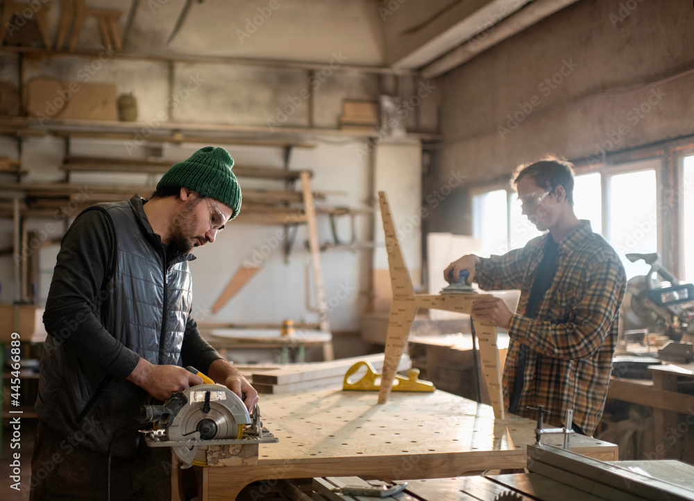 Male carpenters working in workshop Male carpenters working in workshop