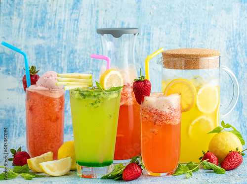 refreshing lemonade with lemon, strawberry and mint on blue background